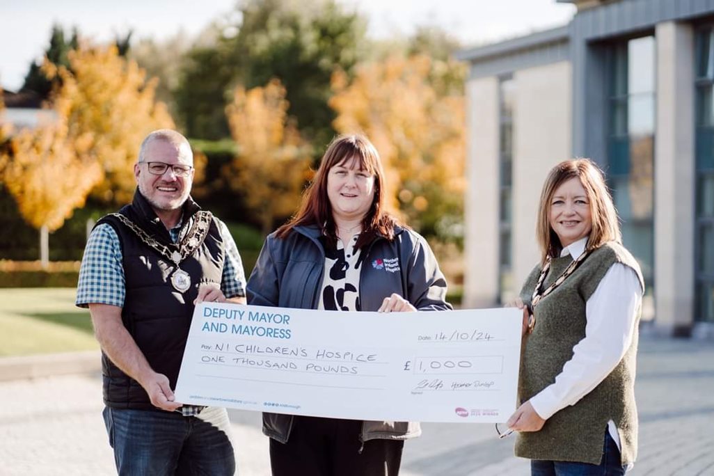 Deputy Mayor and Deputy Maoress presenting cheque to NI Children's Hospice